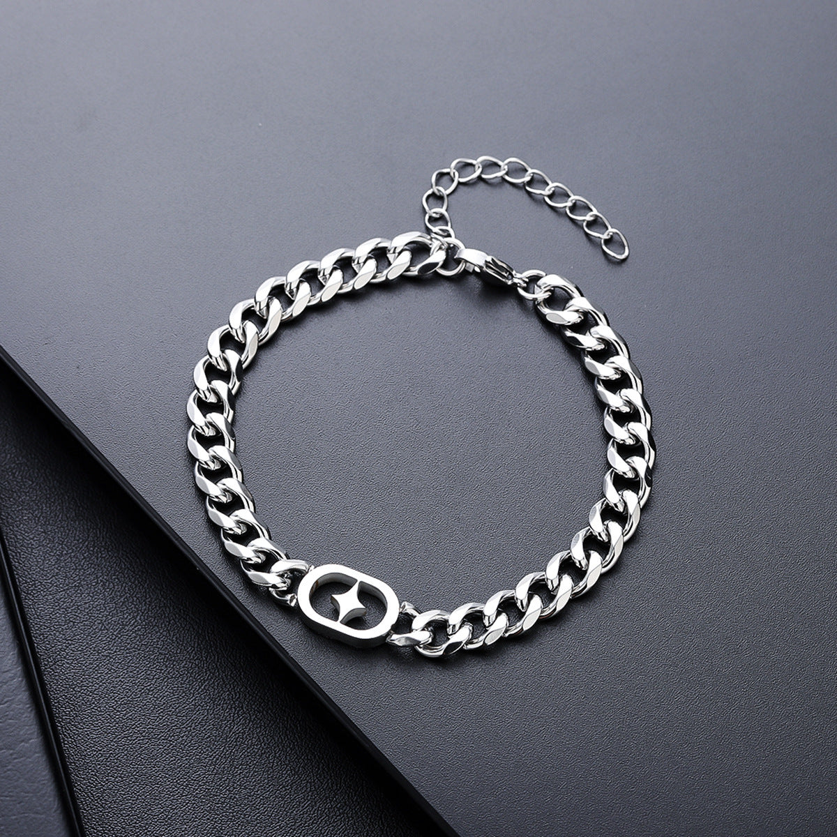 Silver chain bracelet on a dark surface