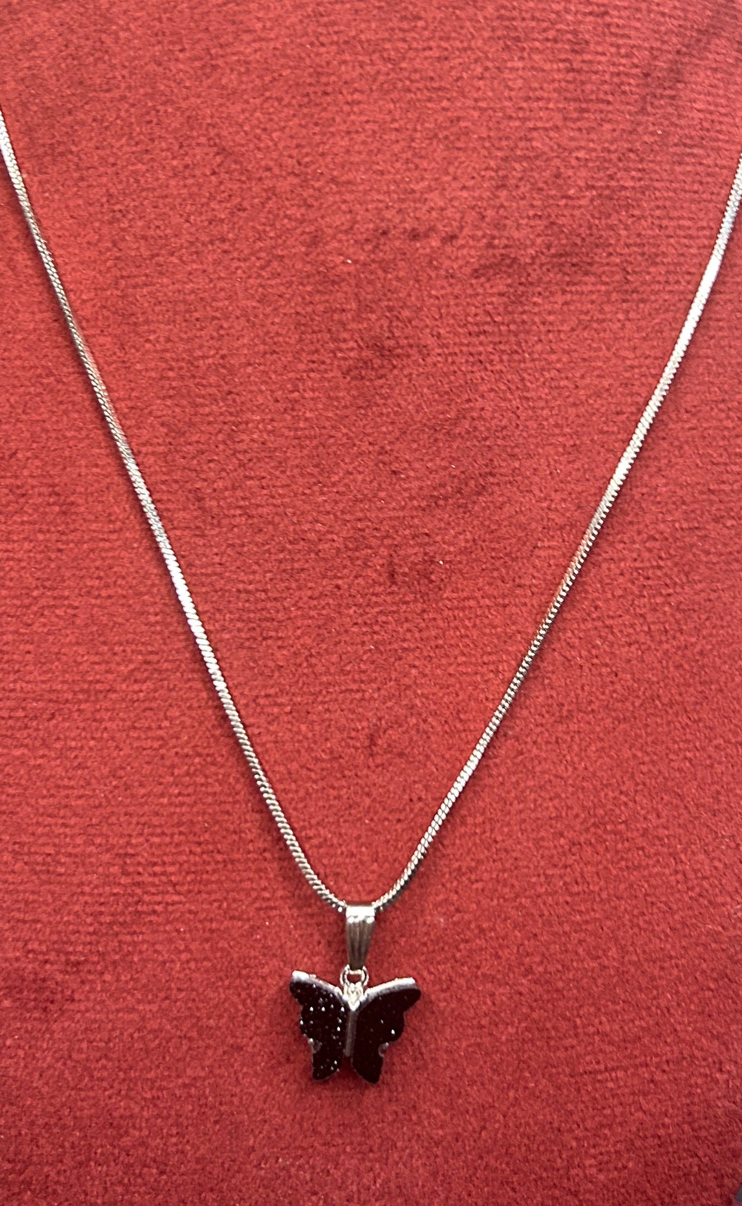 Necklace with a star pendant on a red cushion