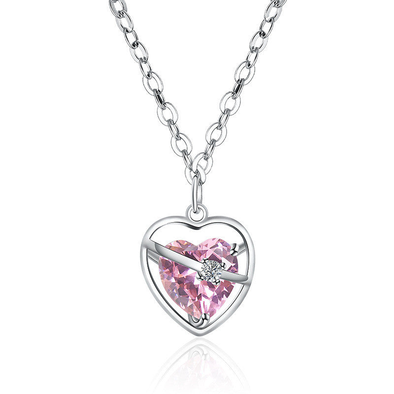 Heart-shaped necklace with pink gemstone on a white background