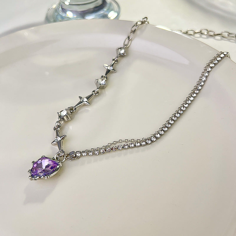 Silver necklace with a purple gemstone on a white plate