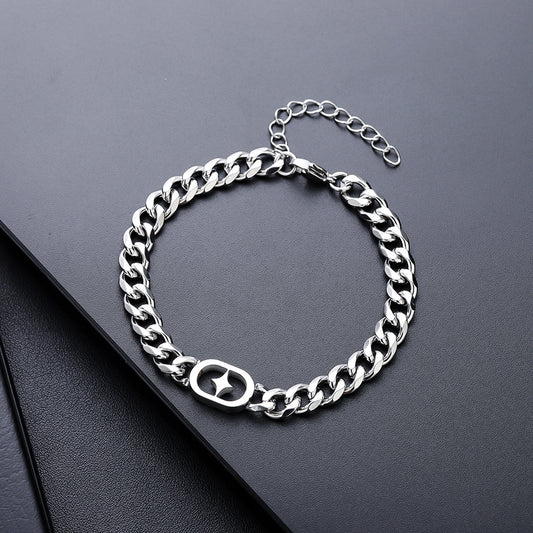 Silver chain bracelet on a dark surface
