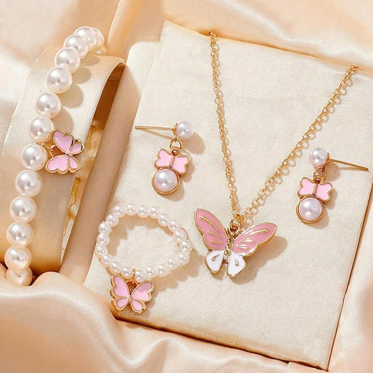 Jewelry set with pink butterfly designs on a beige fabric background