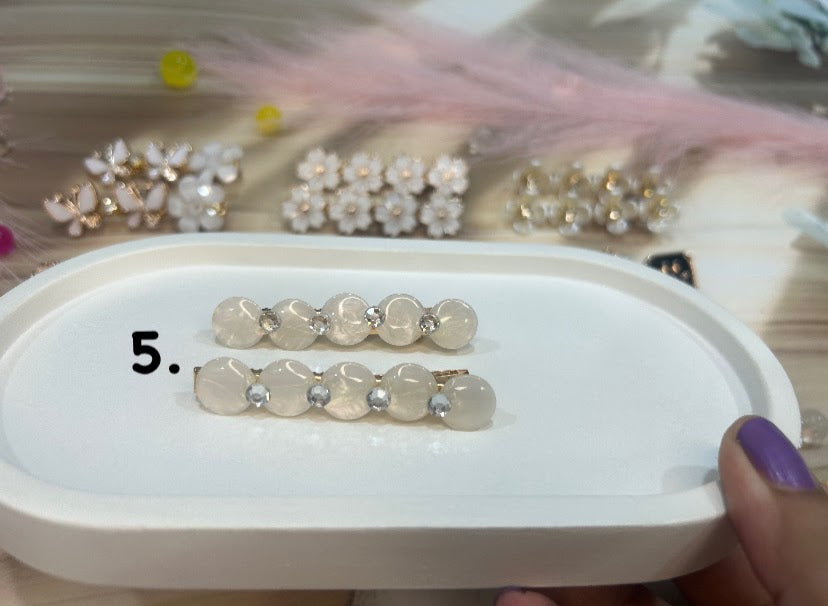 Set of hair clip on a white tray with a blurred background