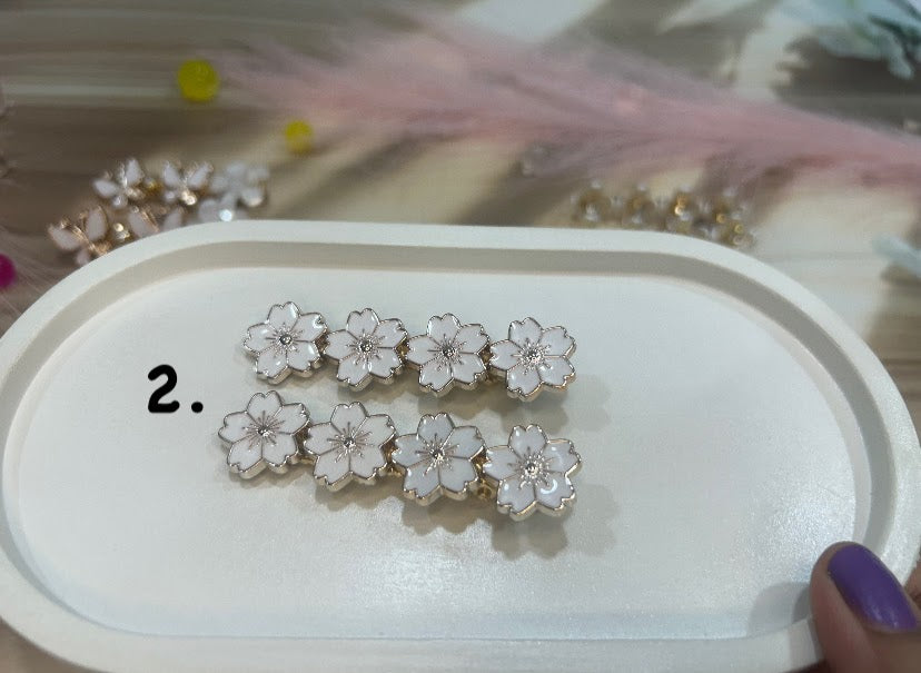 Set of floral hair clip on a white tray with a blurred background