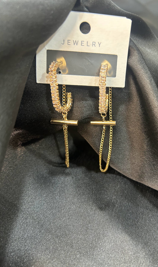 Gold jewelry set on a gray fabric background