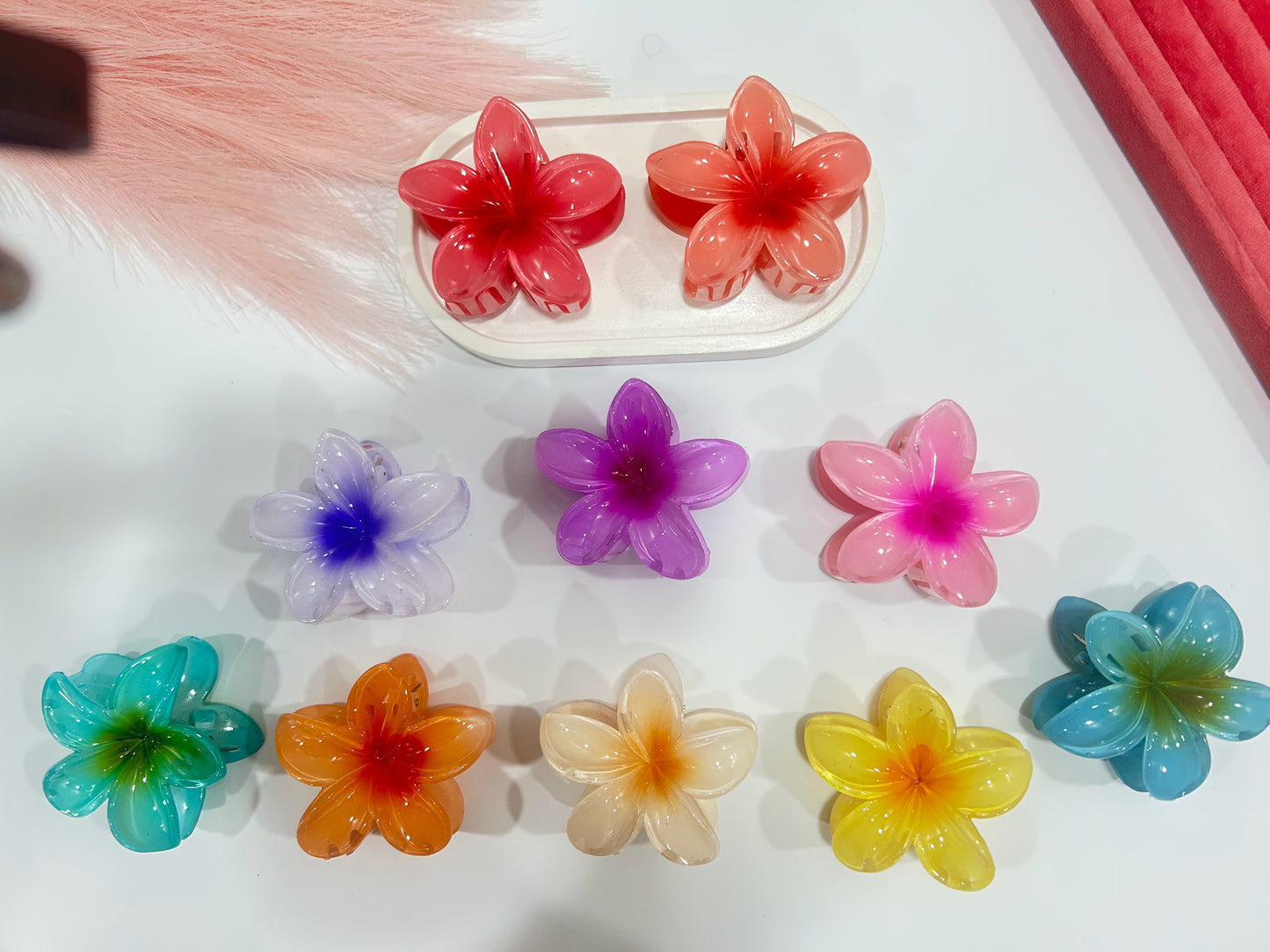 Colorful flower-shaped hair clips on a white surface