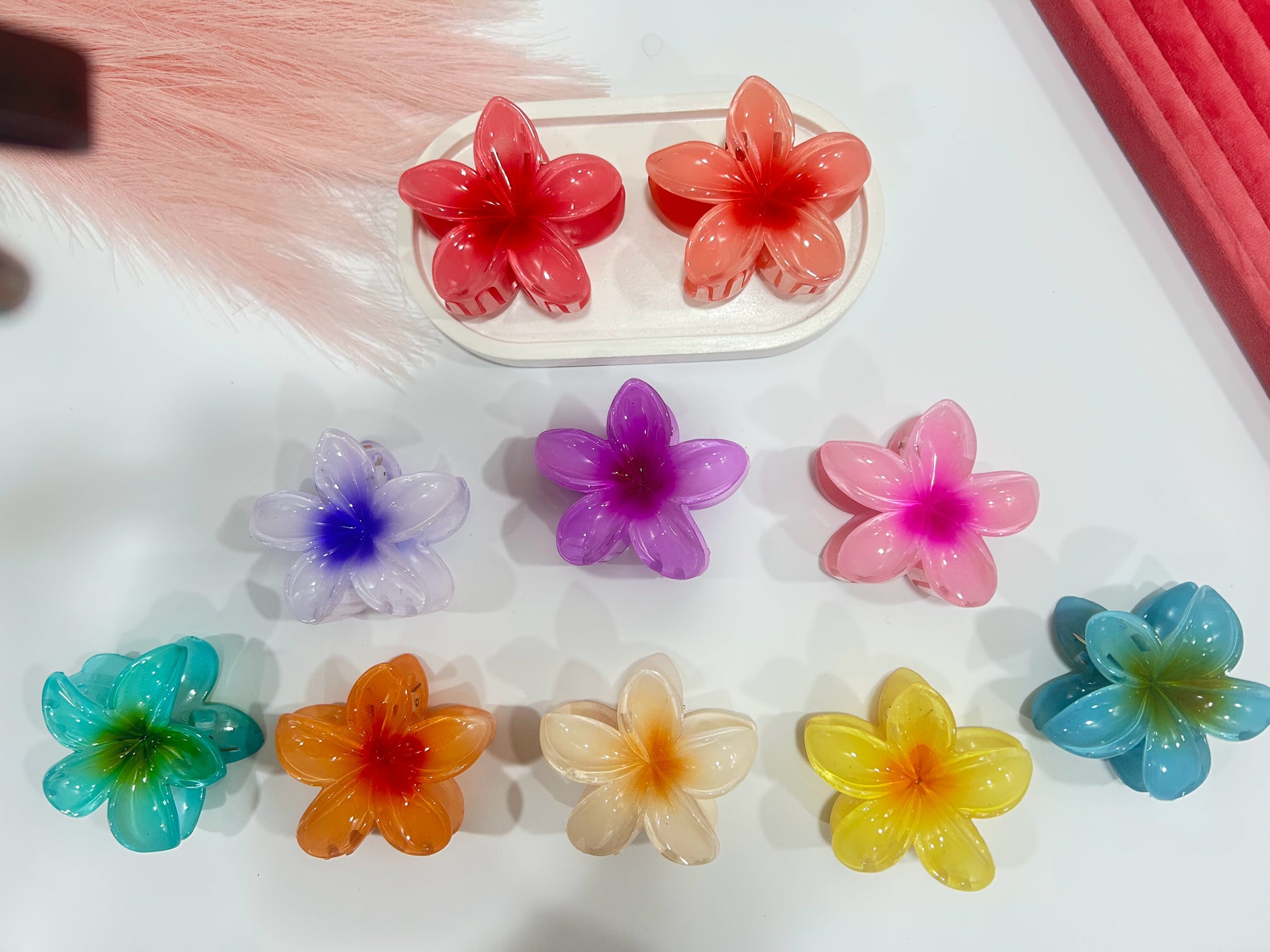 Colorful flower-shaped hair clips on a white surface