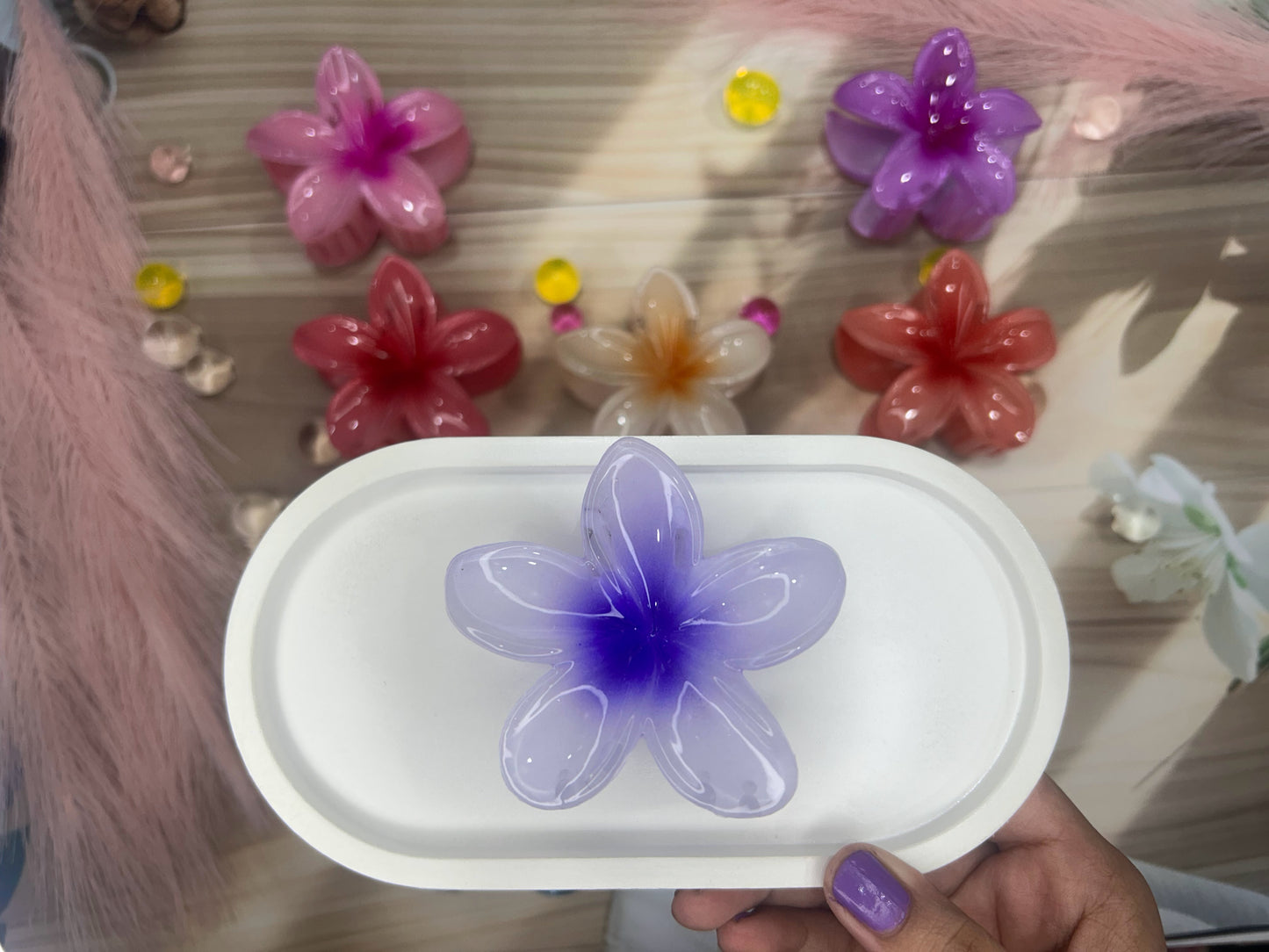 Flower-shaped object on a white tray with decorative flowers in the background