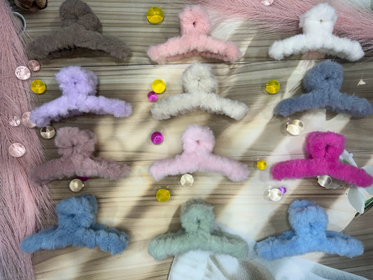 Colorful hair ties on a wooden surface with small decorative items.