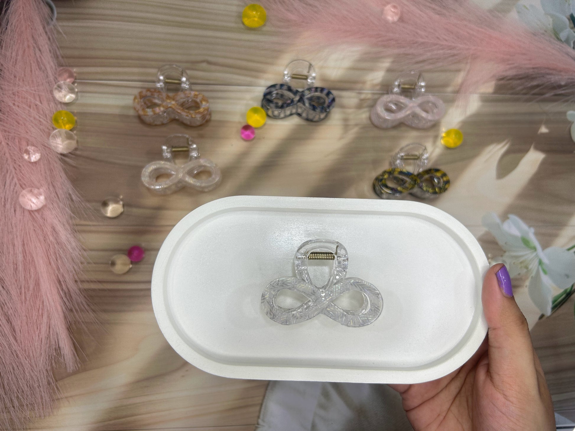 Infinite symbol claw in a white box with blurred background