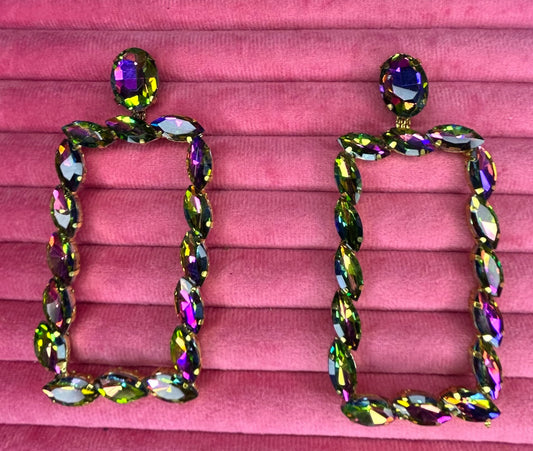 Multicolored gemstone earrings on a pink fabric background