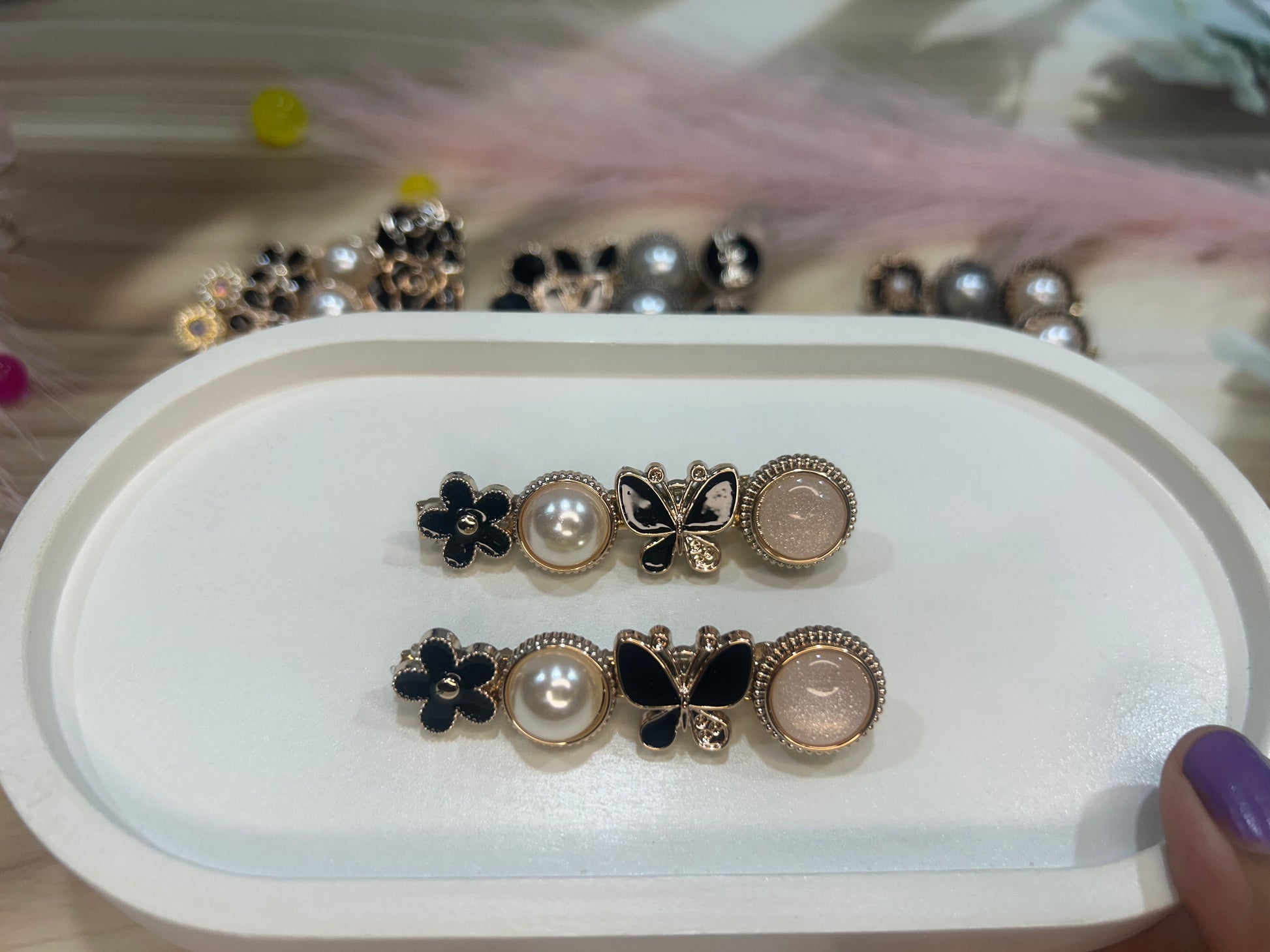 Set of decorative hair clip on a white tray with a blurred background