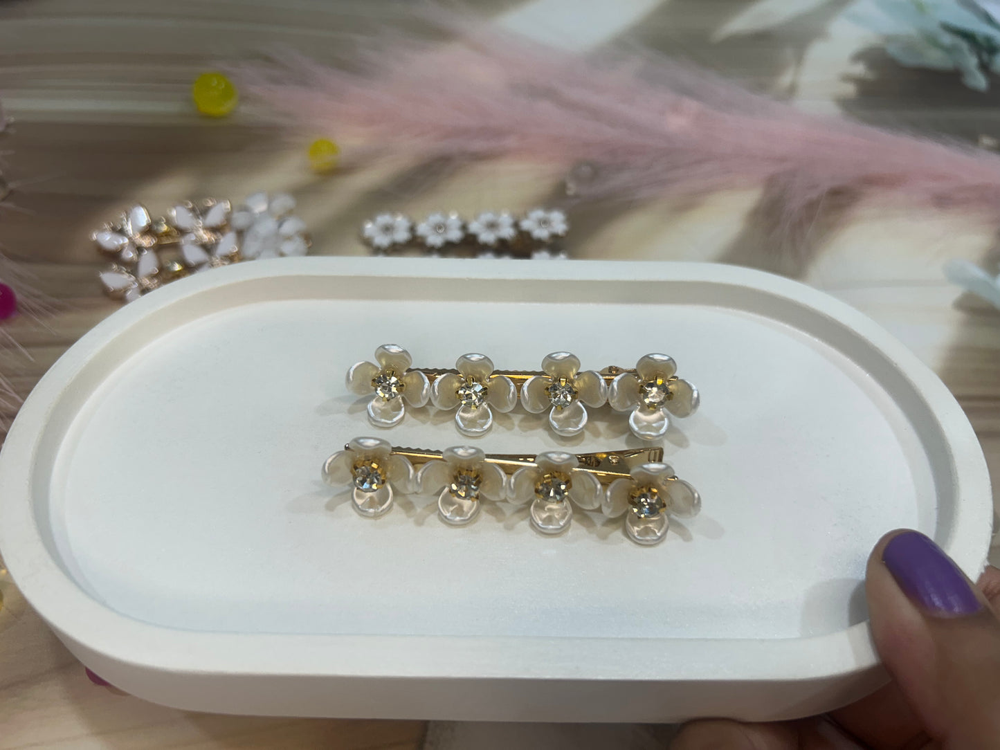 Gold and clear hair clip set on a white tray with blurred background