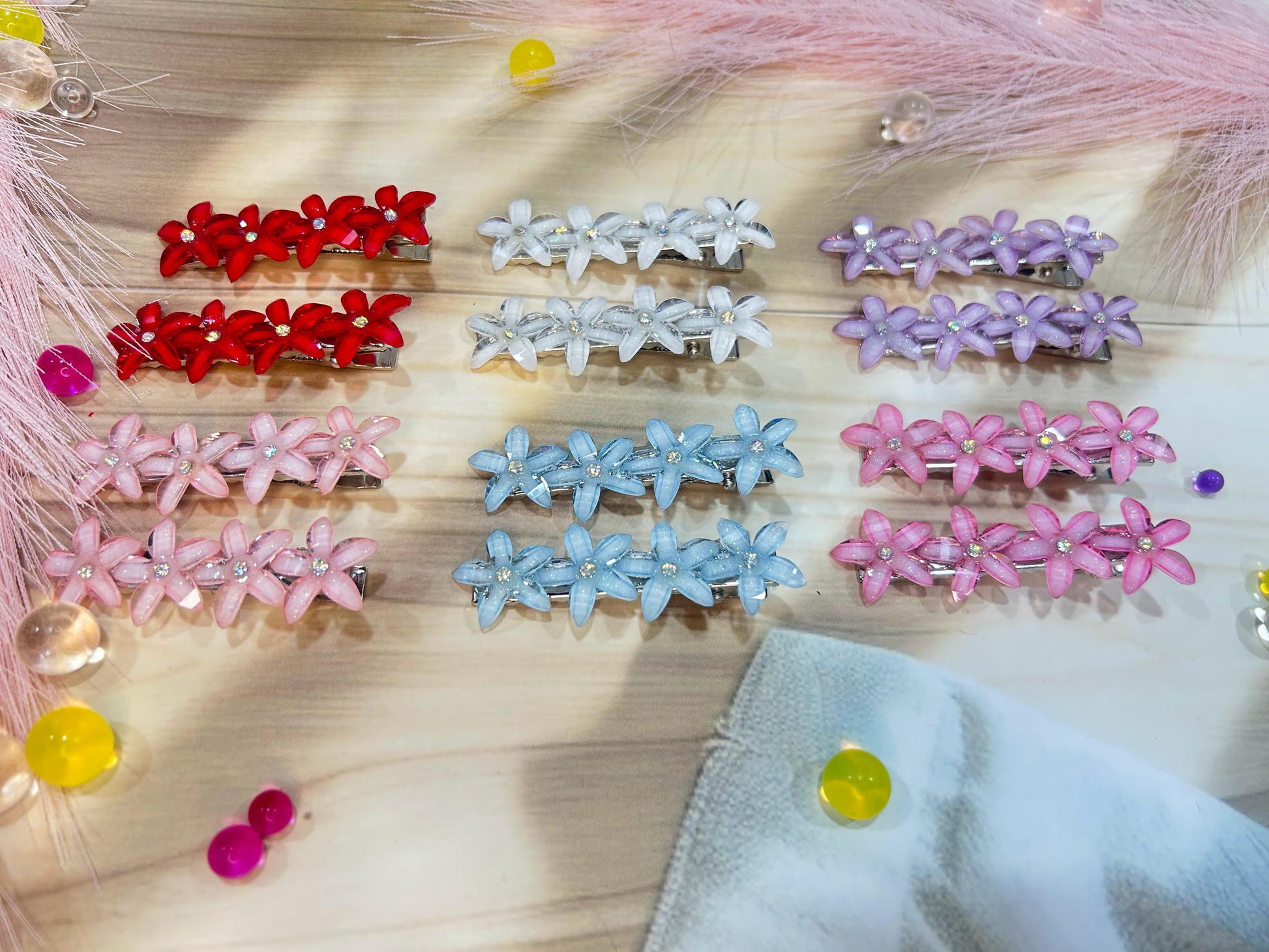 Set of colorful hair clips on a wooden surface