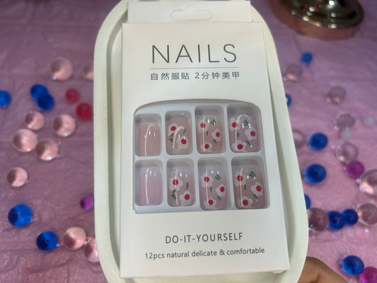 Packaging of nail art stickers with decorative designs on a colorful confetti background.