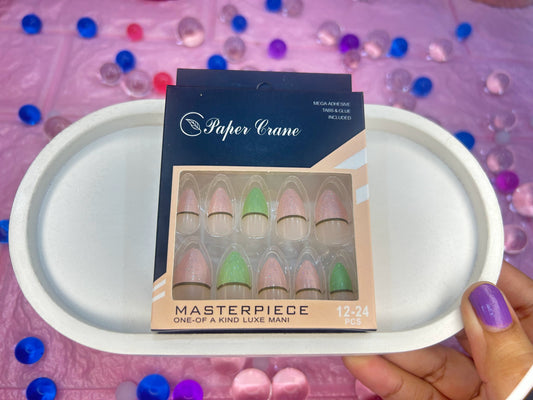 Box of false nails with 'Paper Crane' branding on a white tray against a colorful background.
