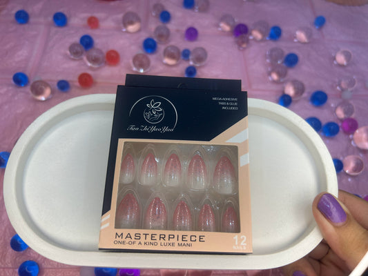 Box of false nails labeled 'Masterpiece' on a white tray with a colorful background
