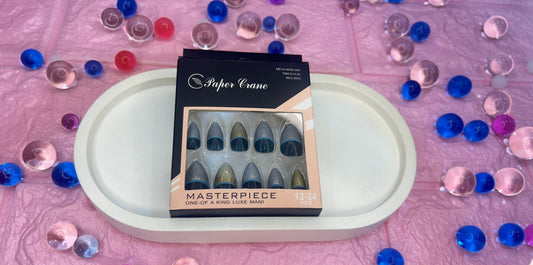 Box of false nails on a white tray with colorful beads on a pink background