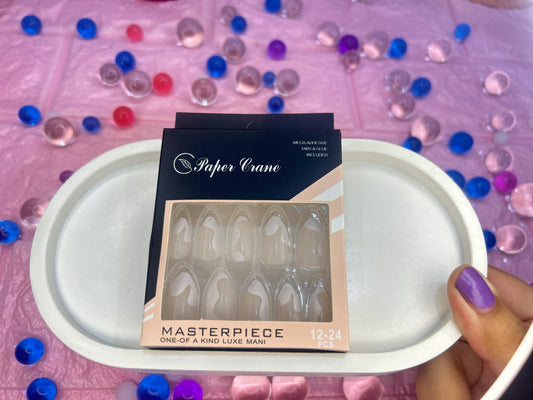 Packaged nail product on a white tray with colorful beads in the background