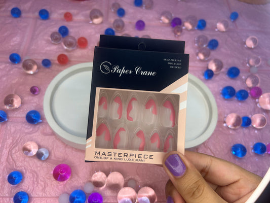 packaging with 'Paper Crane' branding held by a hand against a colorful gemstone background.