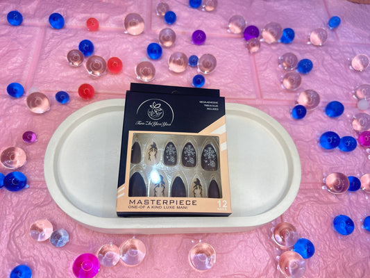 Box of 'Masterpiece' on a white tray with colorful beads on a pink background