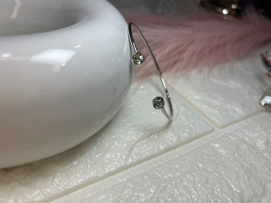 Silver bracelet with beads on a white surface