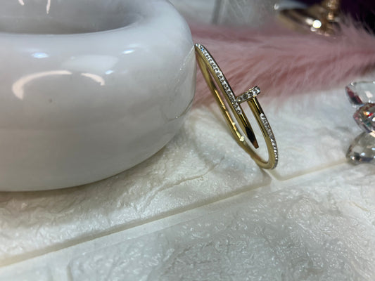 Gold bracelet with diamonds on a textured surface
