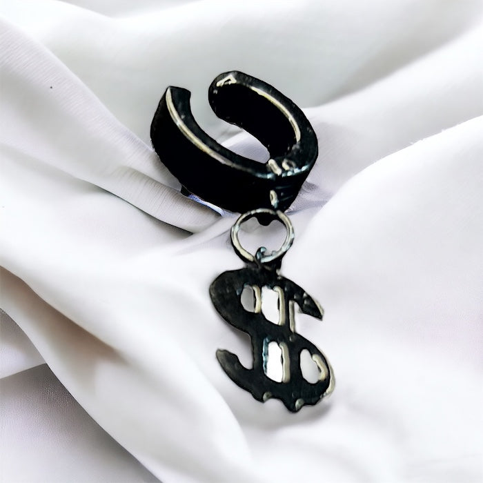 Black hoop earring with a dollar sign charm on a white fabric background